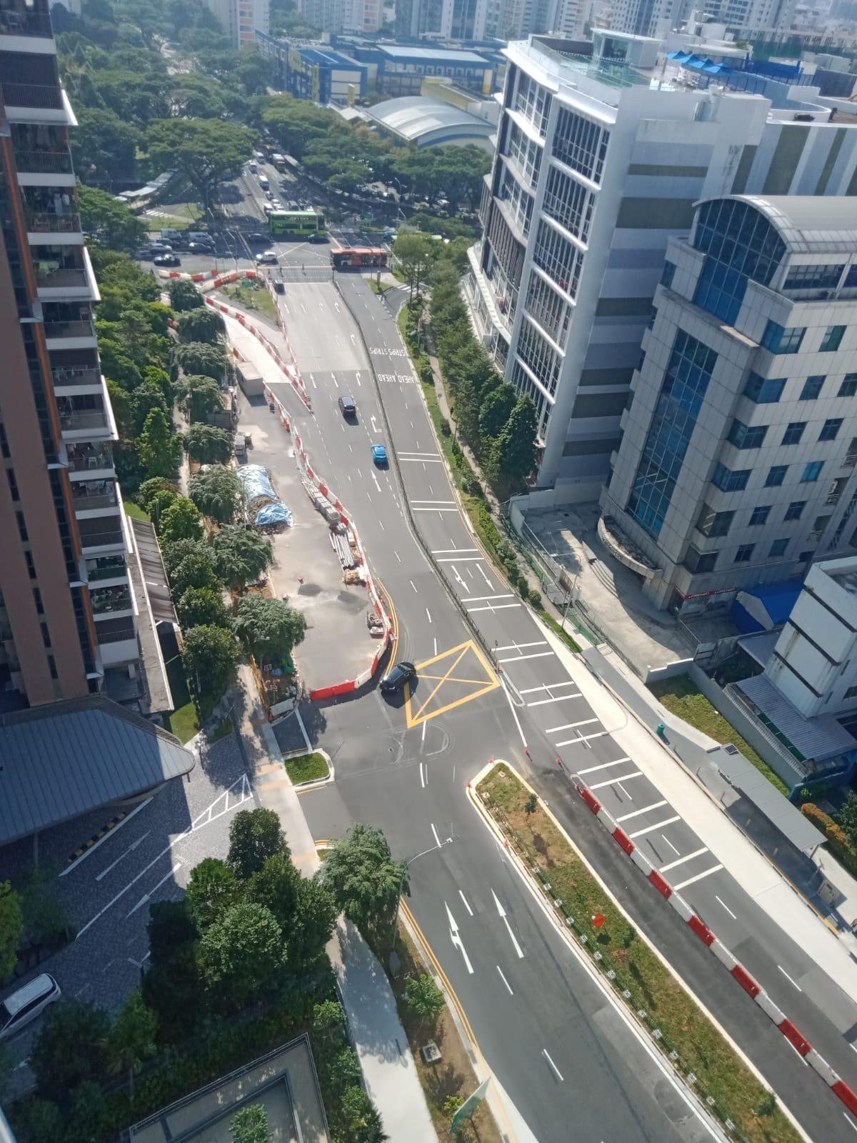 Aerial of completed signalised junction with new road markings serving condominium development