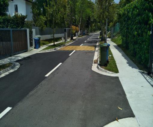Newly resurfaced residential street with footpath and zebra crossing in private estate