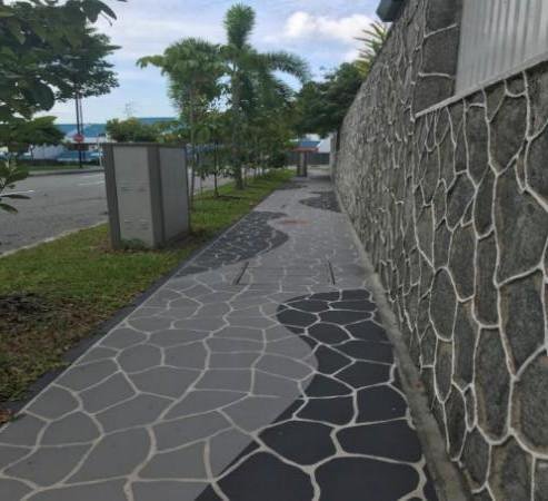 Newly paved heritage-style stone walkway and stone retaining wall