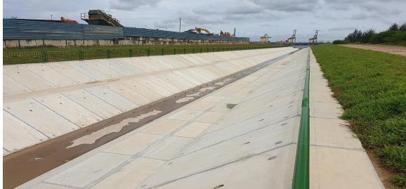 Long coastal drainage outlet alongside container terminal