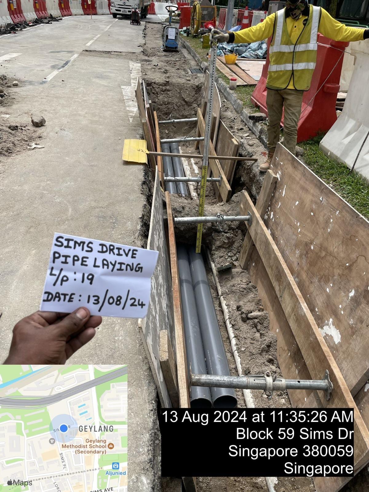 Underground drainage pipe laying in trench at Sims Drive